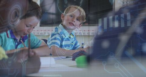 Elementary students collaborating at classroom table with digital technology overlay