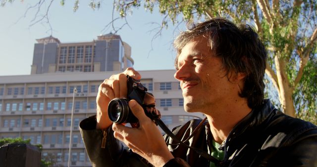 Smiling Photographer Capturing Outdoor Urban Scene in Daylight - Download Free Stock Images Pikwizard.com