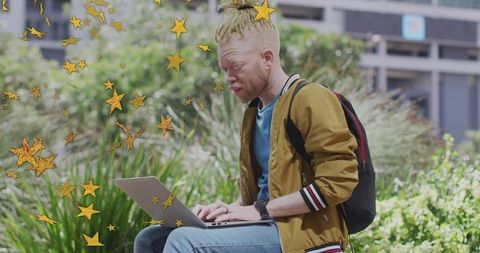 Youthful Man Typing on Laptop in Urban Park with Star Effects
