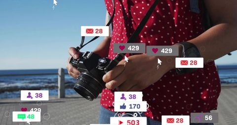 Adjusting dslr on coastal walk with floating social media alerts, woman holding camera