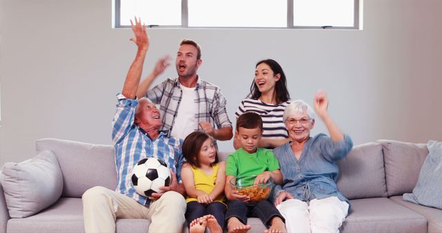 Multigenerational Family Celebrating with Soccer Ball on Sofa - Download Free Stock Images Pikwizard.com