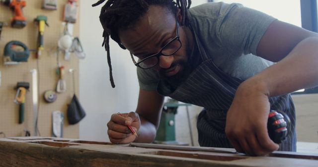 Focused Craftsman Measuring Wood in Workshop - Download Free Stock Images Pikwizard.com