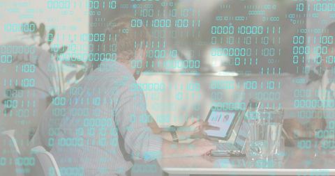 Collaborative team working on laptop and tablet in modern office with binary code overlay