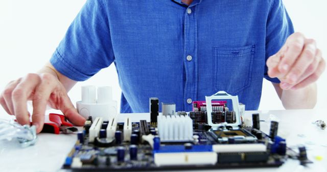 Technician Repairing Hardware at a Desk in Blue Shirt - Download Free Stock Images Pikwizard.com