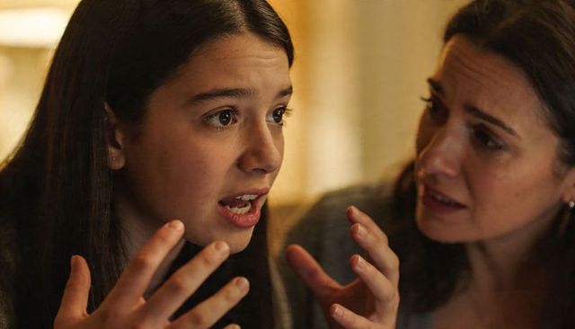 Teenage daughter arguing with mother during emotional night conversation, family tension