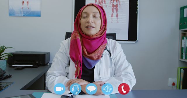 Female Doctor in Hijab Conducting Virtual Consultation via Video Call - Download Free Stock Images Pikwizard.com