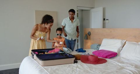 Family Packing for Vacation, Mother and Daughter Teamwork