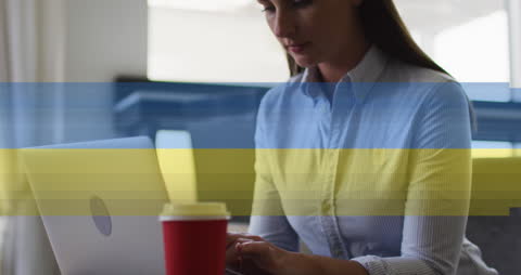 Businesswoman Using Laptop with Digital Overlay in Modern Office