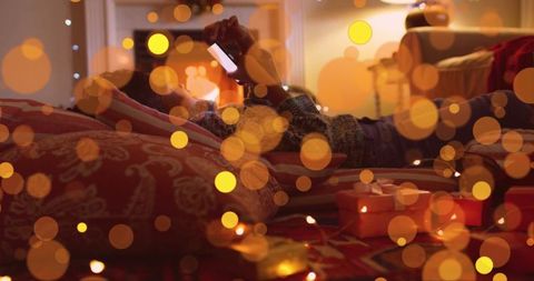 Girl Using Smartphone in Cozy Festive Room with Lights and Gifts