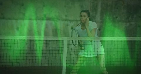 Woman Tennis Player Focused During Night Match