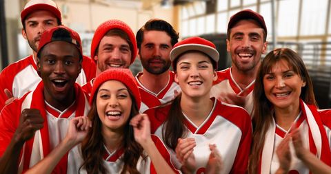 Diverse Sports Fans Energetically Cheering in Red and White Jerseys