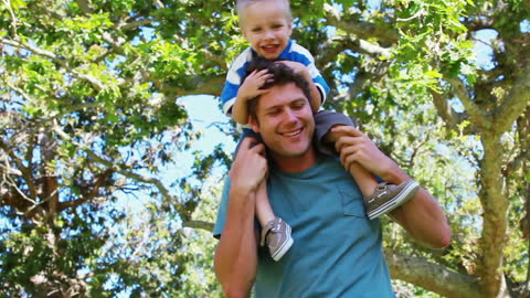 Father Enjoying a Sunny Day with Child in Lush Park