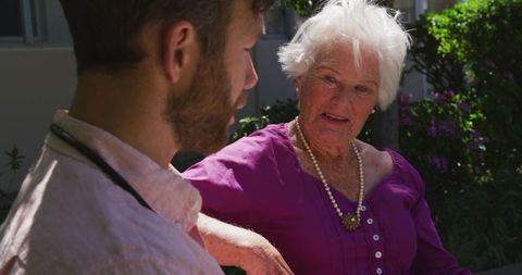 Senior Woman Consulting with Medical Professional Outdoors