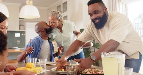 Family Sharing Meal at Dining Table with Joy and Warmth