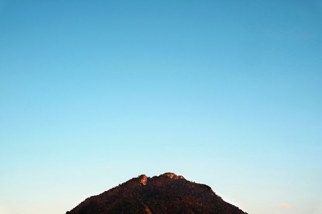 Isolated Mountain Peak against Clear Blue Sky - Download Free Stock Photos Pikwizard.com