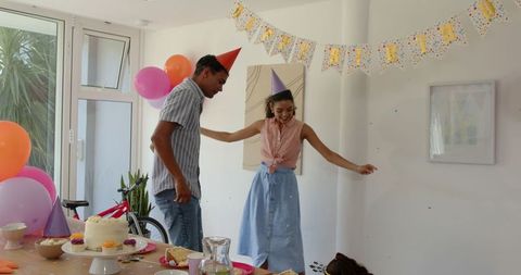 Family Joyfully Celebrating Birthday at Home with Party Decorations