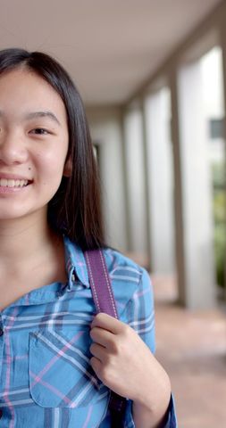 Teen Student Smiling in School Corridor with Backpack - Download Free Stock Images Pikwizard.com