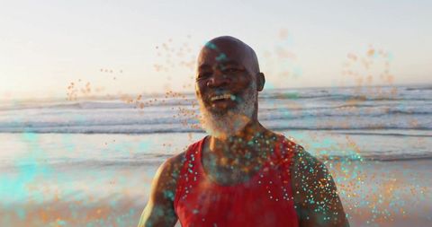 Happy Senior Man with Vibrant Particles at Sunset Beach