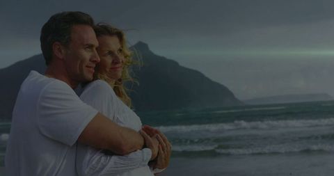 Romantic Couple Embracing by the Dusk Coastline Scenery