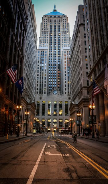 Depicts Chicago's financial district during dusk, featuring tall skyscrapers and empty streets with illuminated street lamps. Ideal for topics involving urban life, city structures, business districts, and travel. Can be used for blogs, travel guides, business websites, or city-related articles.