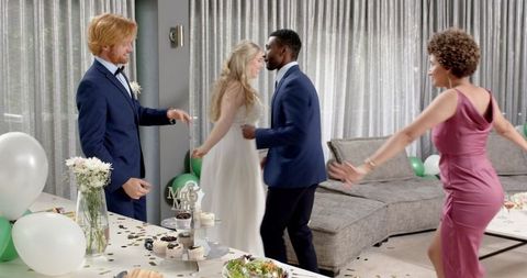 Multiracial Friends Celebrating at Living Room Wedding Reception