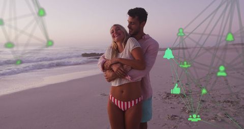 Romantic Couple Embracing on Beach with Digital Icons Overlay