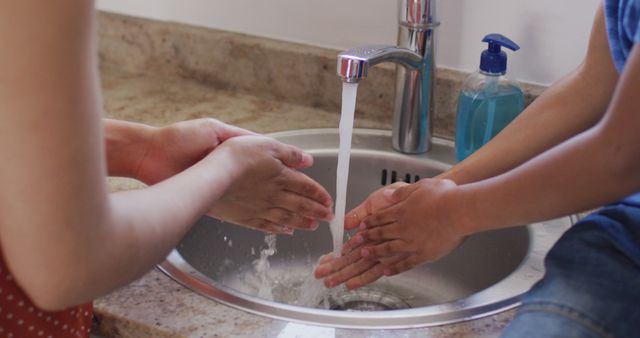 Mother and Child Washing Hands Together at Kitchen Sink - Download Free Stock Images Pikwizard.com