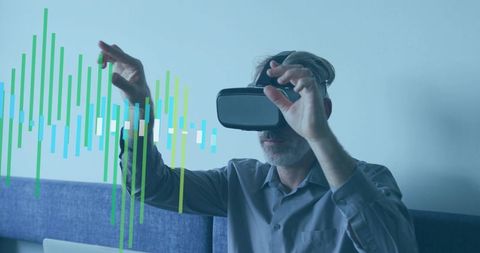 Mature man wearing vr headset manipulating virtual data visualization with hand gestures