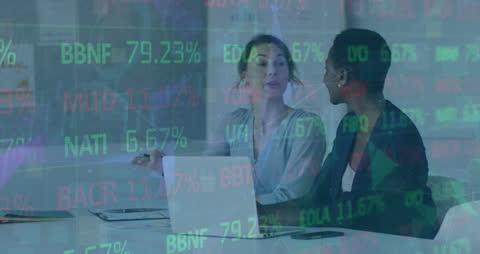 Businesswomen Collaborating in Modern Office with Financial Data Overlay