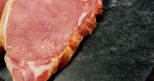 Fresh Raw Pork Chops on Black Cutting Board - Download Free Stock Images Pikwizard.com