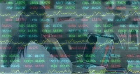 Businesswoman analyzing stock data on laptop in office