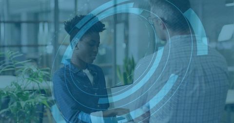 Professionals Collaborating with Digital Interface Overlay in Modern Office