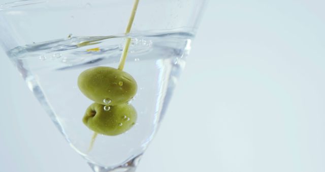 Close-Up of Martini Glass with Olives and Cocktail Stick - Download Free Stock Images Pikwizard.com