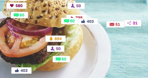 Sesame seed bun burger on white plate attracting social media engagement badges