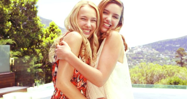 Two Young Women Hugging Outside Smiling in Sunlight - Download Free Stock Images Pikwizard.com