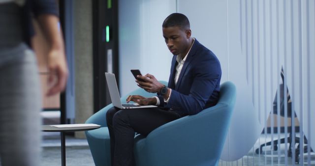 Business Professional Using Smartphone and Laptop in Modern Office Lounge - Download Free Stock Images Pikwizard.com