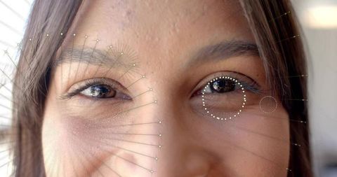 Showing closeup woman eyes with facial landmark mesh and gaze tracking overlay in daylight