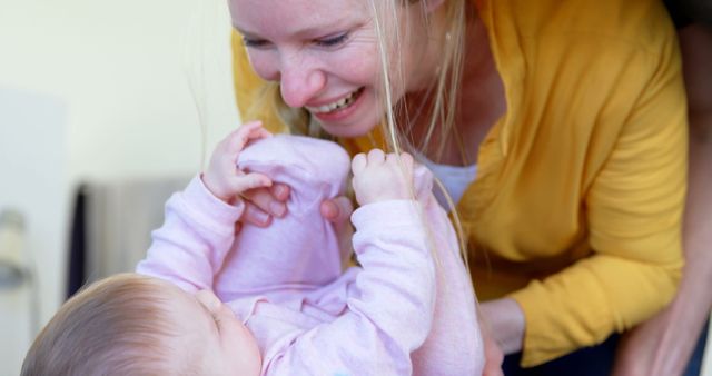 Smiling Mother Playing with Baby in Pink Outfit - Download Free Stock Images Pikwizard.com