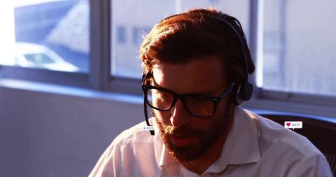 Businessman Using Headset for Customer Communication in Office