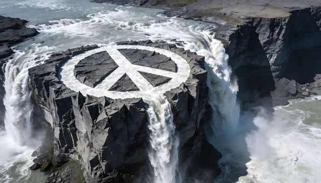 Basalt plateau forming giant peace symbol while water cascading into deep river gorge
