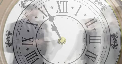 Transparent clock overlapped with blurred businesspeople