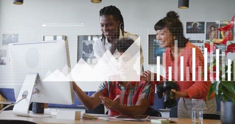 Diverse Team Collaborating on Creative Project in Modern Office with Digital Graphics