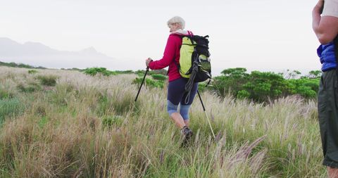 Senior Couple Hiking Through Mountain Grass Fields - Download Free Stock Images Pikwizard.com