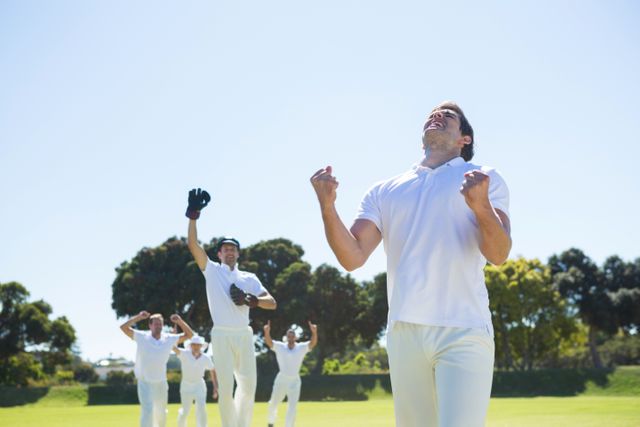 Cricket players celebrating a victory on the field, showing joy and excitement. Ideal for use in sports-related content, teamwork and success themes, promotional materials for cricket events, and articles about sportsmanship and athletic achievements.