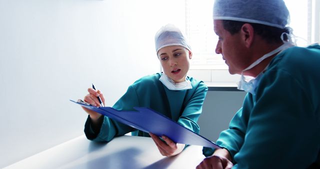 Healthcare Professionals Discussing Patient Records in Hospital - Download Free Stock Images Pikwizard.com