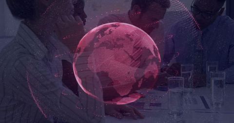 Business Colleagues Reviewing Reports with Holographic Globe