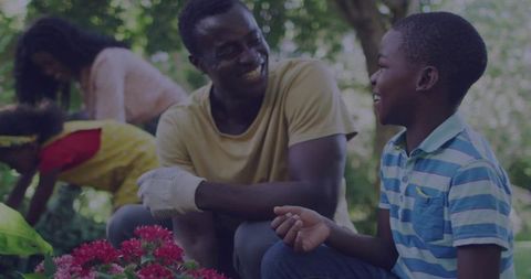 Family Gardening Joy: Father and Son Bonding in Lush Backyard