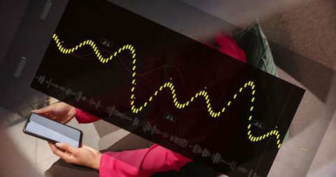 Woman sitting on couch holding smartphone with audio waveform overlay wearing vibrant pink top