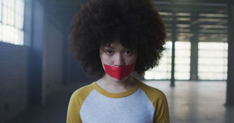 Afro-American Woman with Red Tape Symbolizing Silence