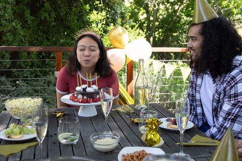 Birthday celebration on outdoor wooden patio with couple
